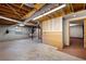 Basement featuring concrete flooring, exposed ducts, and paneled wall accent at 620 Shannon Green Sw Cir, Mableton, GA 30126