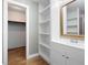 Bathroom featuring hardwood floors and white cabinets with an opening leading to closet at 620 Shannon Green Sw Cir, Mableton, GA 30126