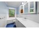 Light blue bathroom featuring a window above the toilet and a white sink at 620 Shannon Green Sw Cir, Mableton, GA 30126
