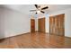 Bedroom with hardwood floors, ceiling fan, and closet with louvered doors at 620 Shannon Green Sw Cir, Mableton, GA 30126
