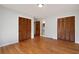 Spacious bedroom with hardwood floors, two closets, and access to the bathroom at 620 Shannon Green Sw Cir, Mableton, GA 30126