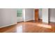 Bedroom featuring hardwood floors and a window with a wooden door at 620 Shannon Green Sw Cir, Mableton, GA 30126