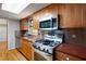 Efficient kitchen with stainless steel appliances and wood cabinets, providing a practical workspace at 620 Shannon Green Sw Cir, Mableton, GA 30126