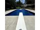 Outdoor in-ground swimming pool featuring diving board and concrete surround at 620 Shannon Green Sw Cir, Mableton, GA 30126