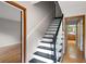 Elegant staircase with wooden rails and contrasting black and white steps, adding visual interest at 620 Shannon Green Sw Cir, Mableton, GA 30126