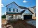 Exterior view of a new two-story home with an attached two-car garage and covered front porch, ready for finishing touches at 72 Warrior Ct, Braselton, GA 30548