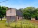 View of the home's back exterior with brick on the bottom half, siding on the top half, and separate storage shed at 10 Hawk Nw Rd, Cartersville, GA 30121
