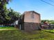 View of the home's back exterior with brick on the bottom half and siding on the top half at 10 Hawk Nw Rd, Cartersville, GA 30121