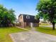 Charming home with a brick facade, shingled roof, small lawn, and separate storage shed at 10 Hawk Nw Rd, Cartersville, GA 30121