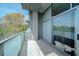 Private balcony with glass railings offers a serene outdoor space with views of lush trees at 130 Arizona Ne Ave # 309, Atlanta, GA 30307