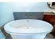 Bright, modern bathtub with stylish mosaic tile backsplash and luxury fixtures in an upscale bathroom at 130 Arizona Ne Ave # 309, Atlanta, GA 30307