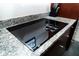 Sleek glass cooktop integrated into the granite countertop with modern knobs and stainless steel accents at 130 Arizona Ne Ave # 309, Atlanta, GA 30307