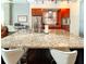 Close-up of a kitchen island with granite countertop, sink, and seating for casual dining at 130 Arizona Ne Ave # 309, Atlanta, GA 30307