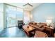 Inviting living room with modern ceiling fan, comfortable leather furniture, and sun-filled balcony access at 130 Arizona Ne Ave # 309, Atlanta, GA 30307