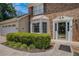 Close-up of the home's entrance showcasing the glass accented door and well-maintained landscaping at 130 Floss Flower Ct, Roswell, GA 30076