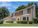 Charming front exterior with brick and siding, bay windows, manicured lawn, and mature trees at 130 Floss Flower Ct, Roswell, GA 30076
