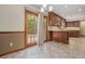 Open kitchen area with wood cabinets and access to the outdoor patio at 130 Floss Flower Ct, Roswell, GA 30076