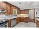 Kitchen with wooden cabinets, stainless steel appliances and plenty of natural light at 130 Floss Flower Ct, Roswell, GA 30076