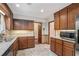 Traditional kitchen featuring wooden cabinets, stainless steel appliances, and tiled backsplash at 130 Floss Flower Ct, Roswell, GA 30076