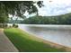 Scenic view of a tranquil lake surrounded by lush greenery, offering a serene and picturesque setting at 130 Floss Flower Ct, Roswell, GA 30076