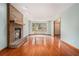 Inviting living room with a brick fireplace and gleaming hardwood floors at 130 Floss Flower Ct, Roswell, GA 30076