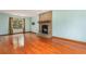 Cozy living room with a brick fireplace and hardwood floors at 130 Floss Flower Ct, Roswell, GA 30076