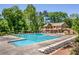 Large community pool surrounded by lounge chairs and lush greenery, perfect for relaxation at 130 Floss Flower Ct, Roswell, GA 30076
