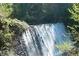 Scenic waterfall cascading over natural rocks surrounded by lush greenery at 130 Floss Flower Ct, Roswell, GA 30076