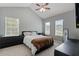 Well-lit bedroom featuring a bed, dresser, and large window at 1914 Phillips Lake Blf, Lithonia, GA 30058