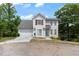 Charming two-story home with gray siding, attached garage, and well-maintained front yard at 1914 Phillips Lake Blf, Lithonia, GA 30058