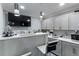 A stylish wet bar with counter seating, grey shaker cabinets, and stainless appliances at 1914 Phillips Lake Blf, Lithonia, GA 30058