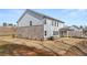 A spacious backyard surrounded by new construction homes under a blue sky at 219 Whispering Pines Ave, Conyers, GA 30094