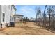A spacious backyard with an air conditioning unit visible and newly planted trees at 219 Whispering Pines Ave, Conyers, GA 30094