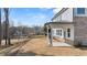 Backyard featuring a covered patio and a view of the surrounding neighborhood at 219 Whispering Pines Ave, Conyers, GA 30094