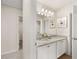 Bright bathroom with a double sink vanity, granite countertops, and decorative mirrors at 219 Whispering Pines Ave, Conyers, GA 30094