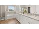 Bright bathroom featuring double vanity sinks, a tub, and a separate shower at 219 Whispering Pines Ave, Conyers, GA 30094