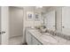 Well-lit bathroom featuring a granite countertop, double sinks, and framed decorative art at 219 Whispering Pines Ave, Conyers, GA 30094