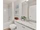Well-lit bathroom with a granite countertop, modern fixtures, and a bathtub-shower combination at 219 Whispering Pines Ave, Conyers, GA 30094