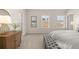 Bedroom showcasing three windows, a gray bench and dresser creating a comfortable and inviting atmosphere at 219 Whispering Pines Ave, Conyers, GA 30094
