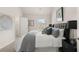 Bedroom showcasing a plush bed, a window, and a door to a walk-in closet for ample storage at 219 Whispering Pines Ave, Conyers, GA 30094