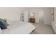 Bedroom featuring neutral-toned decor, a vanity and views to the bathroom and closet ensuring comfort and functionality at 219 Whispering Pines Ave, Conyers, GA 30094