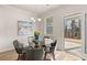 Charming dining area features a glass top table, seating for six, and sliding door access to the patio at 219 Whispering Pines Ave, Conyers, GA 30094
