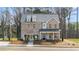 Beautiful two-story brick home with a covered porch and well-manicured front yard in a suburban setting at 219 Whispering Pines Ave, Conyers, GA 30094