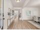 Bright foyer with hardwood floors, console table, and artwork leading to the dining area and staircase at 219 Whispering Pines Ave, Conyers, GA 30094