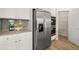 This open kitchen boasts stainless steel appliances, granite counters, white cabinets, and a walk-in pantry at 219 Whispering Pines Ave, Conyers, GA 30094