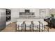 An open kitchen features an island with barstool seating, granite countertops, and stainless steel appliances at 219 Whispering Pines Ave, Conyers, GA 30094