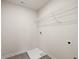 Practical laundry room with washer and dryer hookups and a wire storage shelf at 219 Whispering Pines Ave, Conyers, GA 30094