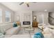 This bright living room features a modern fireplace, hardwood flooring, neutral walls, and lots of light at 219 Whispering Pines Ave, Conyers, GA 30094