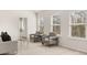 Seating area in spacious main bedroom with plush carpet and natural light at 219 Whispering Pines Ave, Conyers, GA 30094