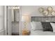 Stylish main bedroom featuring a decorative headboard and ensuite bathroom entrance at 219 Whispering Pines Ave, Conyers, GA 30094